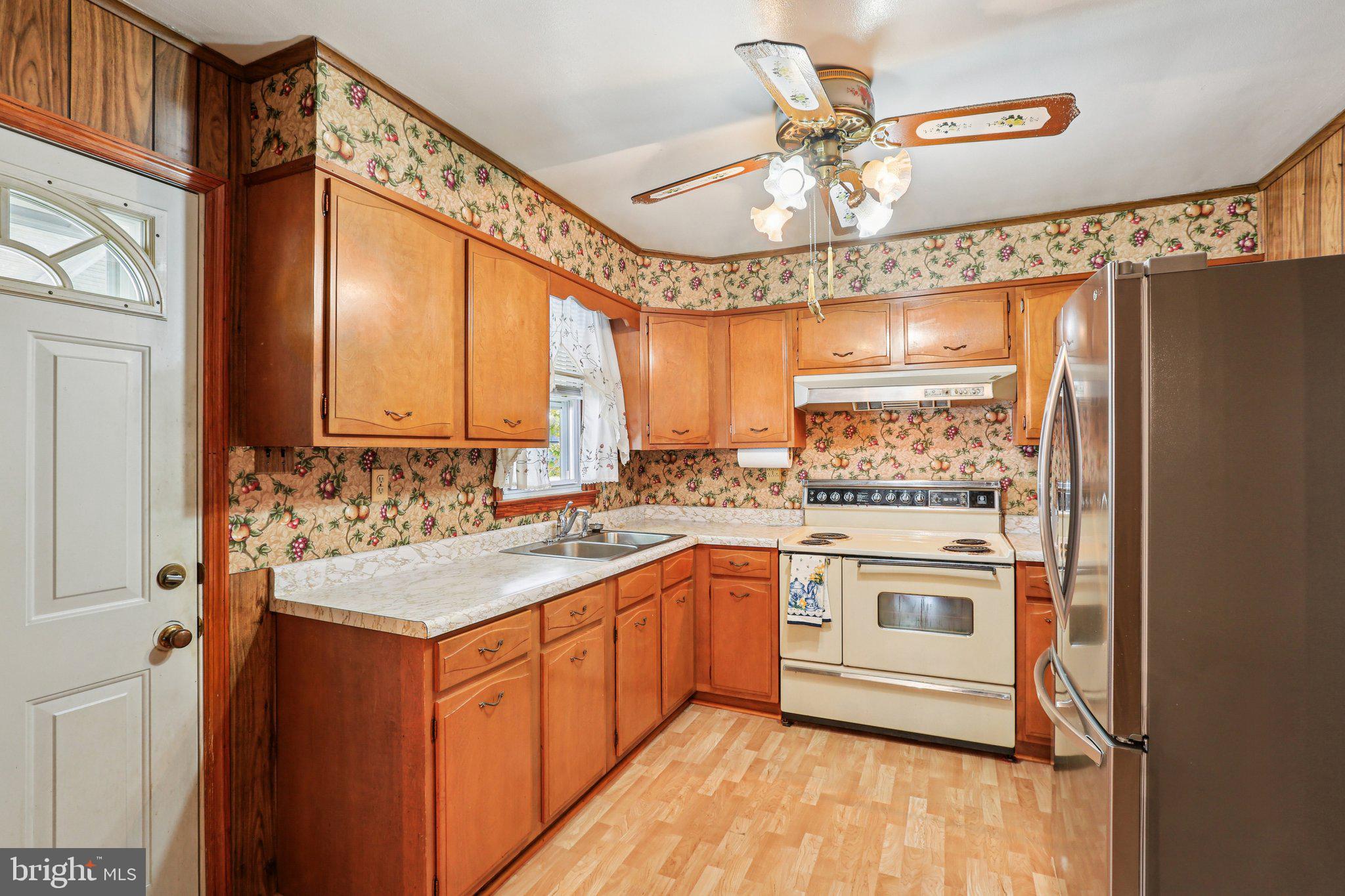 316 Holy Cross Road Brooklyn, MD 21225 - Photo 10 of 32 a kitchen with a sink stove and cabinets