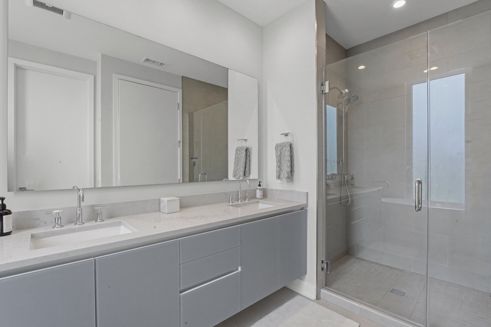 360 West Erie Street, Unit 5A Chicago, IL 60654 - Photo 11 of 32 a bathroom with a shower sink and mirror