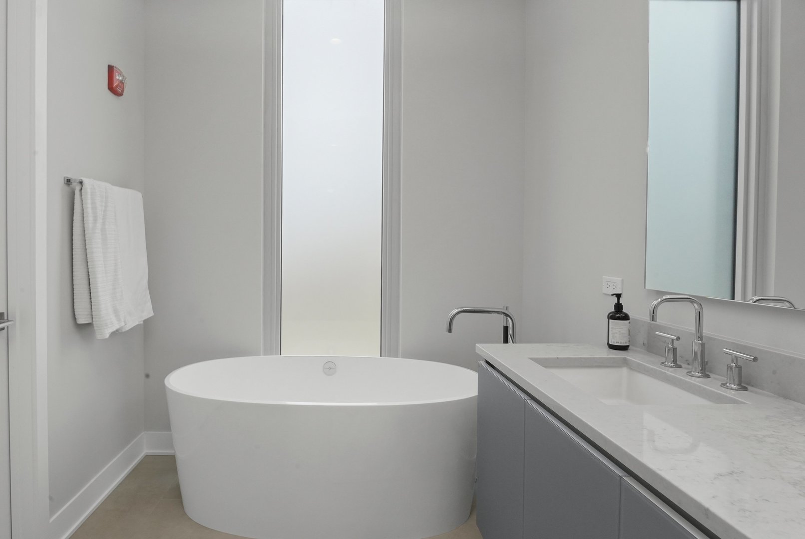 360 West Erie Street, Unit 5A Chicago, IL 60654 - Photo 12 of 32 a bathroom with a sink and a mirror