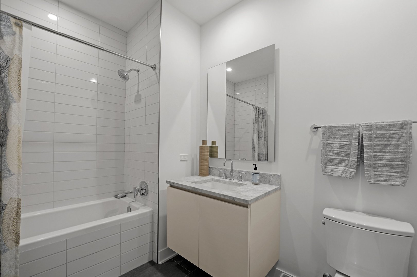 360 West Erie Street, Unit 5A Chicago, IL 60654 - Photo 17 of 32 a bathroom with a sink a toilet and shower