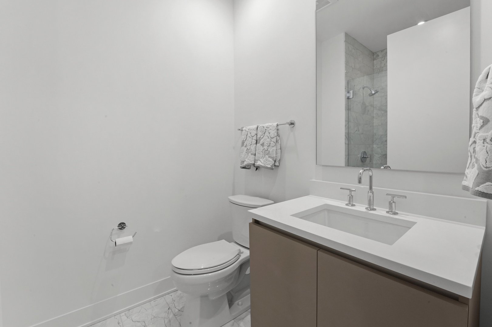 360 West Erie Street, Unit 5A Chicago, IL 60654 - Photo 21 of 32 a bathroom with a sink a toilet and mirror