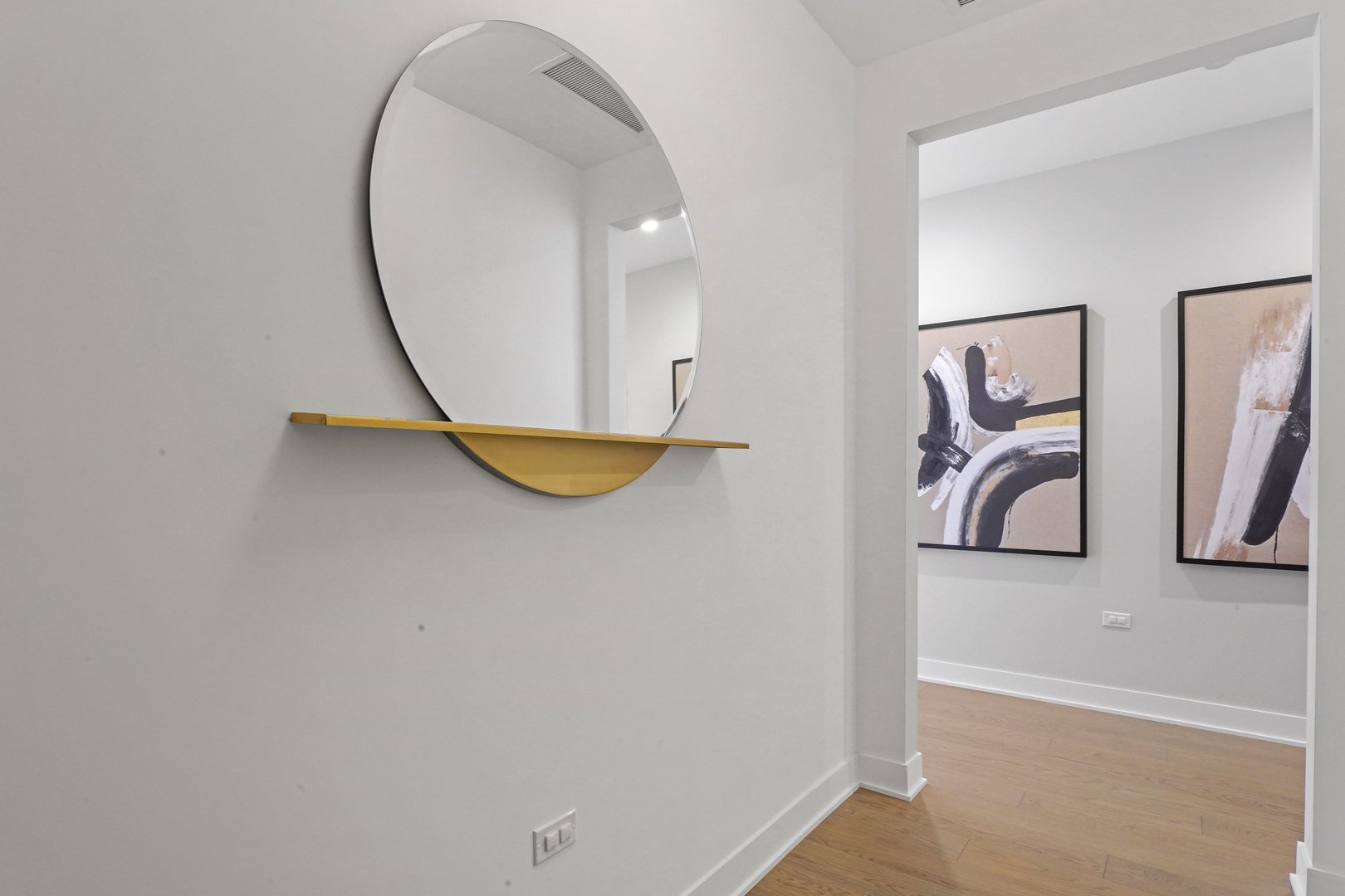 360 West Erie Street, Unit 5A Chicago, IL 60654 - Photo 23 of 32 a view of a hallway with paintings on the wall