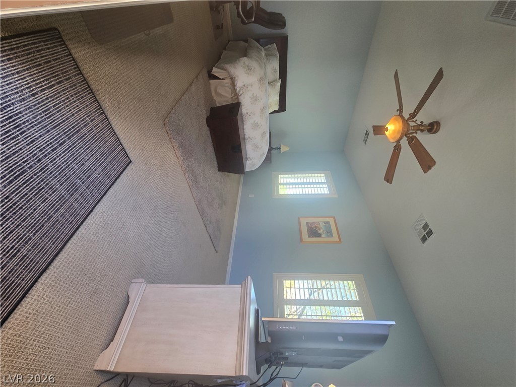 2567 Dirleton Place Henderson, NV 89044 - Photo 49 of 67 Casita Bedroom- Off front of entry. A well-lit bedroom features a vaulted ceiling and a ceiling fan for comfort.