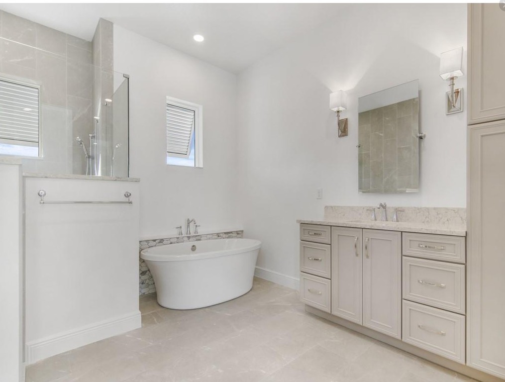 5865 Palmetto Preserve Road Vero Beach, FL 32967 - Photo 4 of 7 a bathroom with a sink mirror and a bathtub