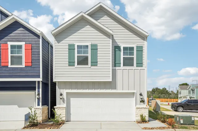 a front view of a house with outdoor seating