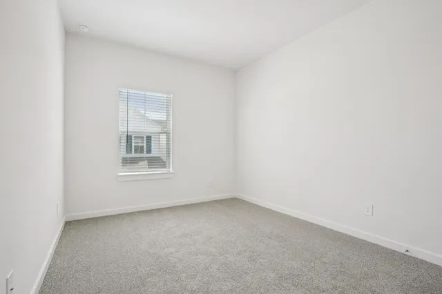 a bedroom with a bed and a potted plant