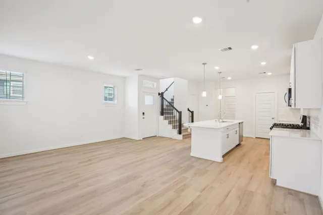 a view of a kitchen with a sink and a stove top oven