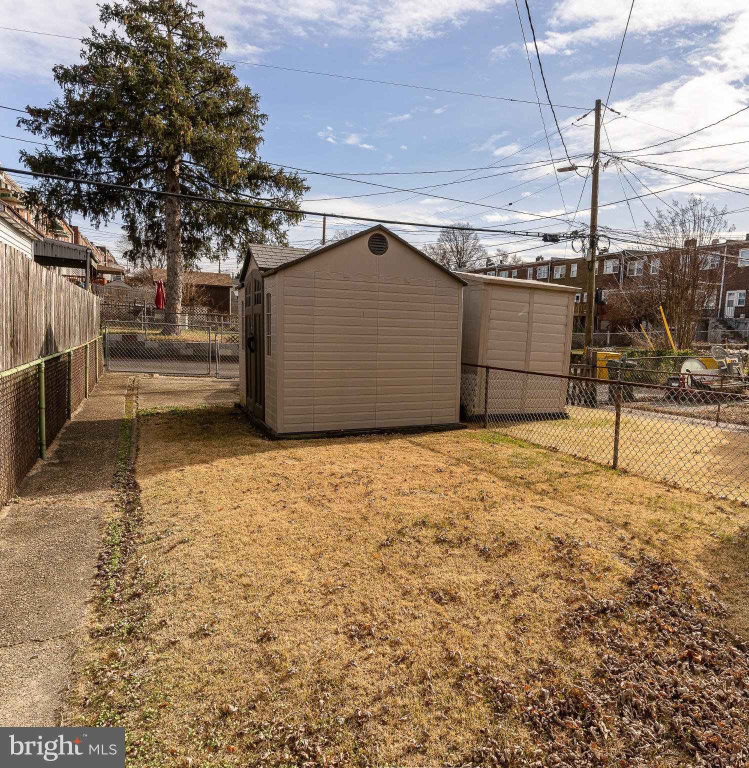 407 Old Riverside Road Baltimore, MD 21225 - Photo 9 of 27 Spacious yard with utility sheds and greenery.