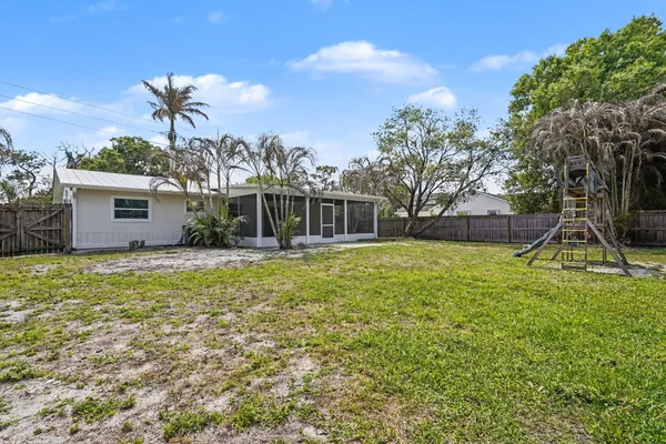a view of kitchen with refrigerator and window