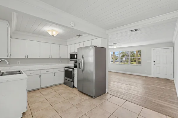 a kitchen with stainless steel appliances granite countertop a refrigerator sink and cabinets