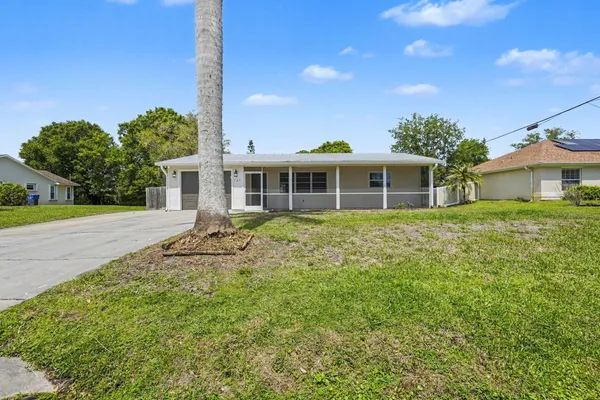 an empty room with wooden floor and window