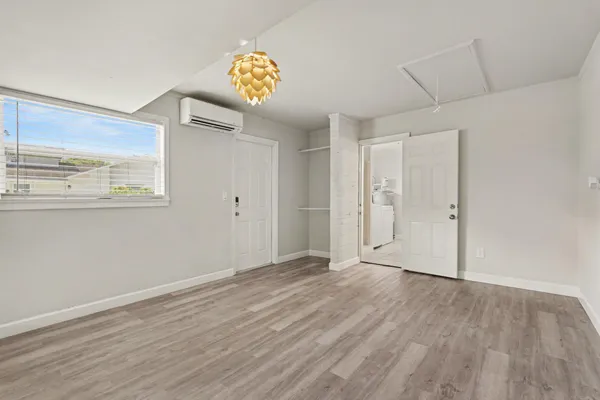 a view of a room with wooden floor and window