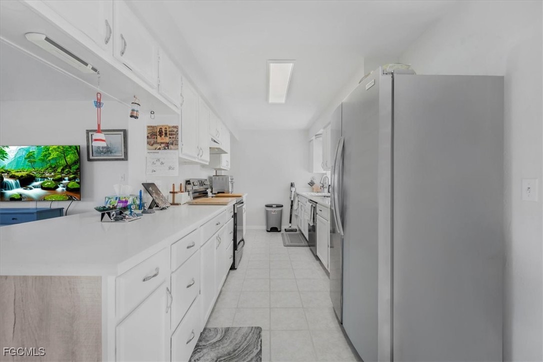 13239 Caribbean Boulevard Fort Myers, FL 33905 - Photo 13 of 37 a kitchen with cabinets and white appliances