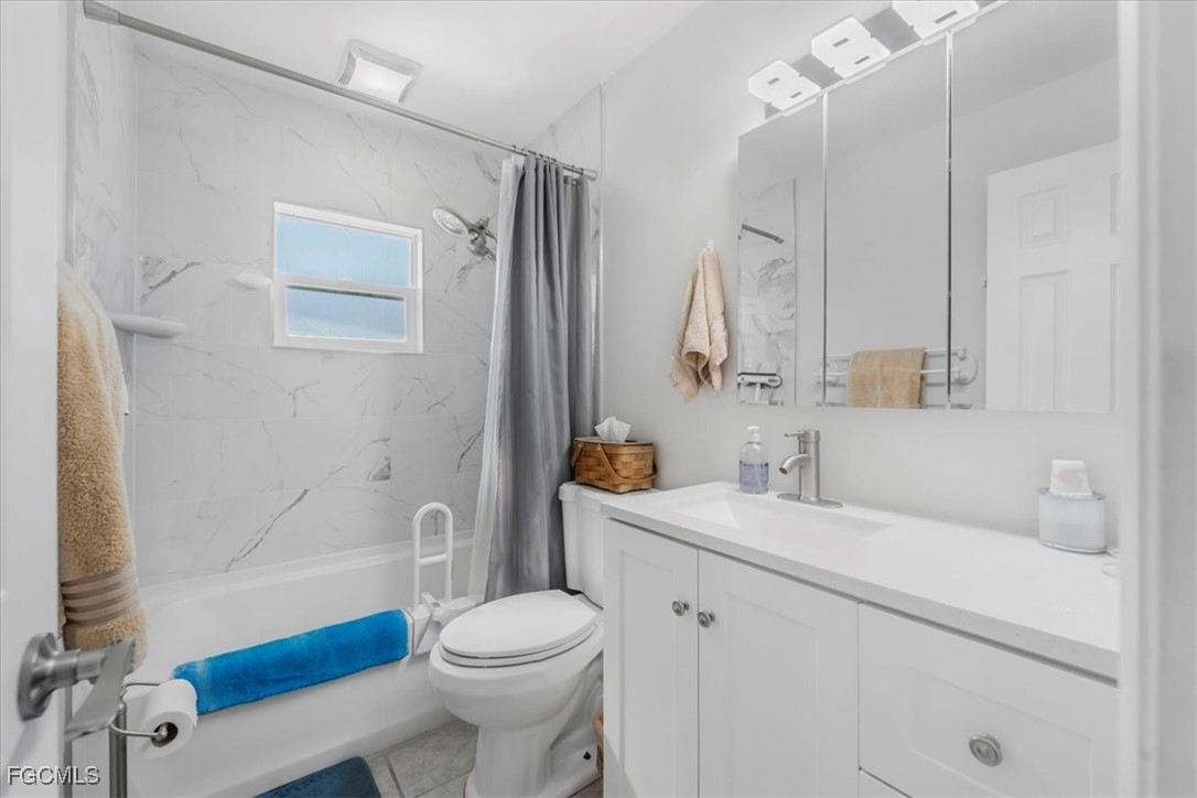 13239 Caribbean Boulevard Fort Myers, FL 33905 - Photo 18 of 37 a bathroom with a sink a toilet and shower