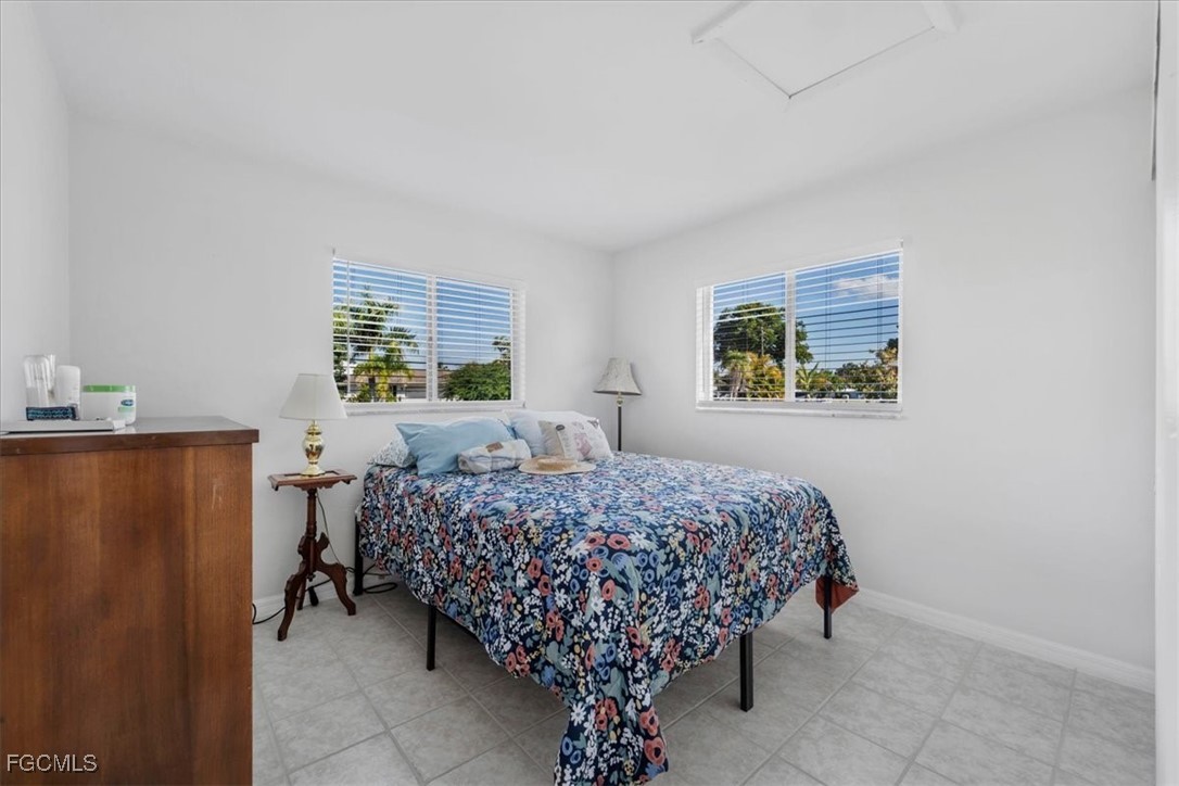 13239 Caribbean Boulevard Fort Myers, FL 33905 - Photo 19 of 37 a bed sitting in a bedroom next to a window
