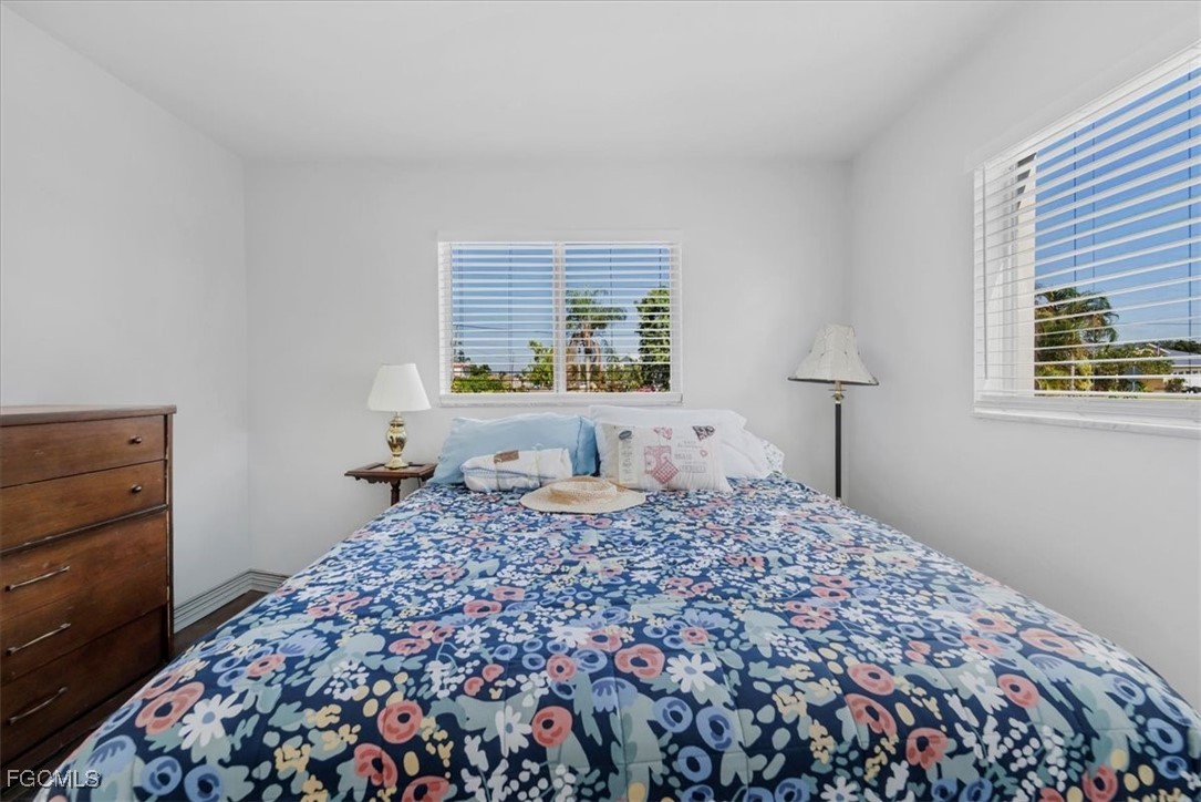 13239 Caribbean Boulevard Fort Myers, FL 33905 - Photo 20 of 37 a bedroom with a bed and a dresser next to a window