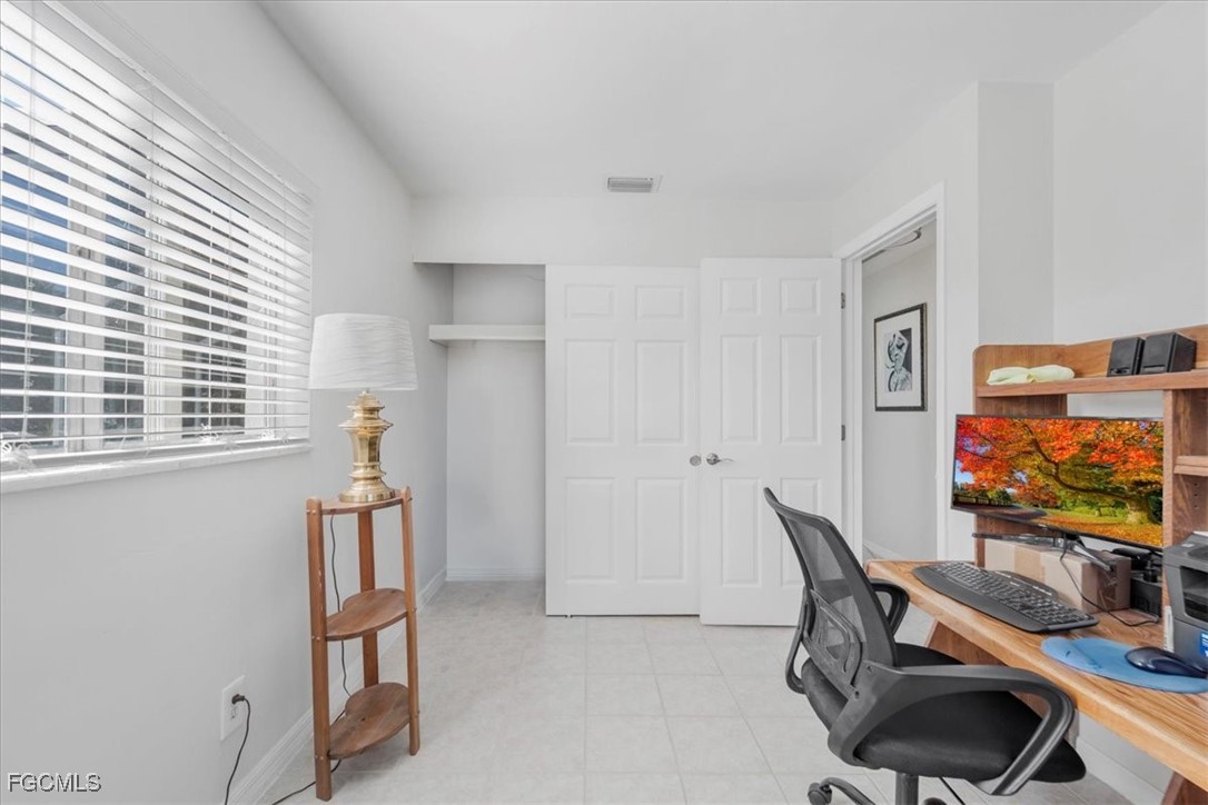 13239 Caribbean Boulevard Fort Myers, FL 33905 - Photo 22 of 37 a room with furniture and a flat screen tv