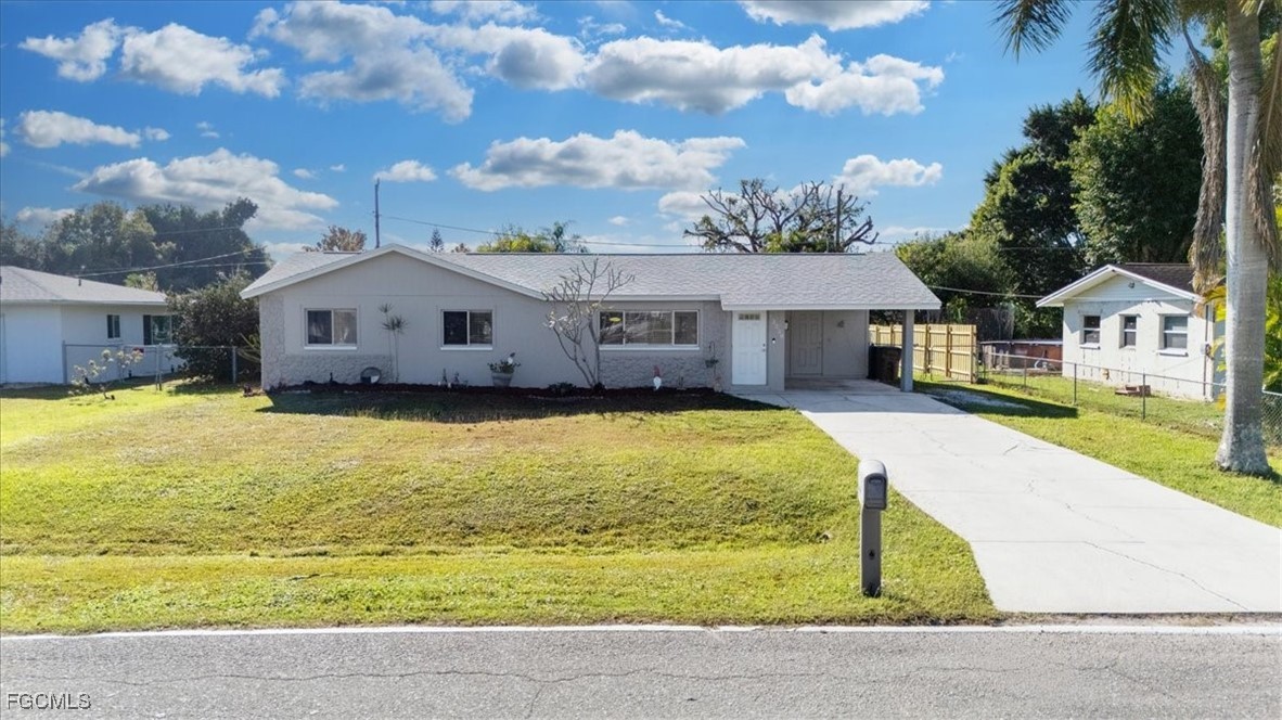 13239 Caribbean Boulevard Fort Myers, FL 33905 - Photo 3 of 37 a front view of a house with swimming pool