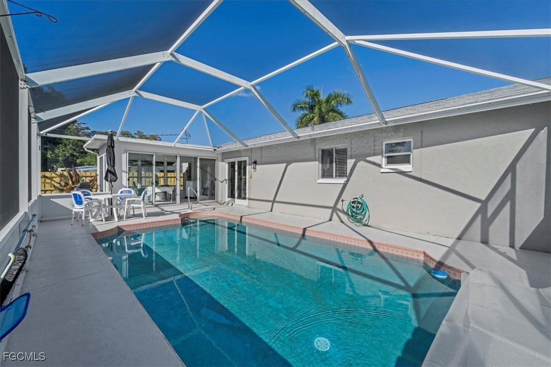 13239 Caribbean Boulevard Fort Myers, FL 33905 - Photo 31 of 37 a view of a patio with table and chairs potted plants with wooden floor