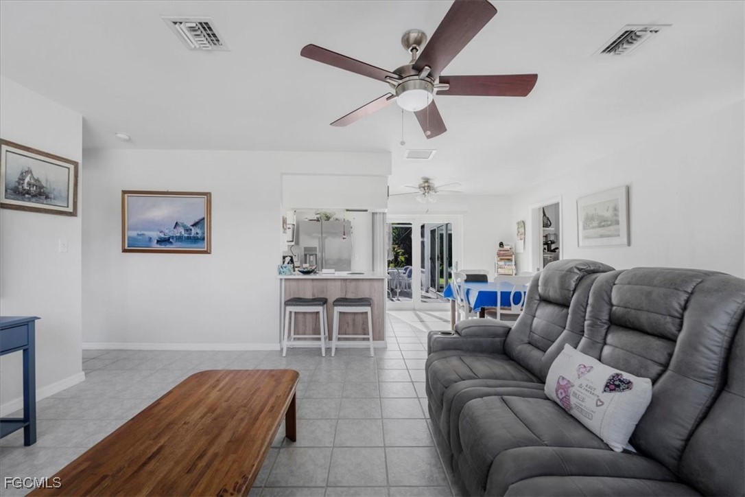13239 Caribbean Boulevard Fort Myers, FL 33905 - Photo 6 of 37 a living room with furniture and a view of kitchen