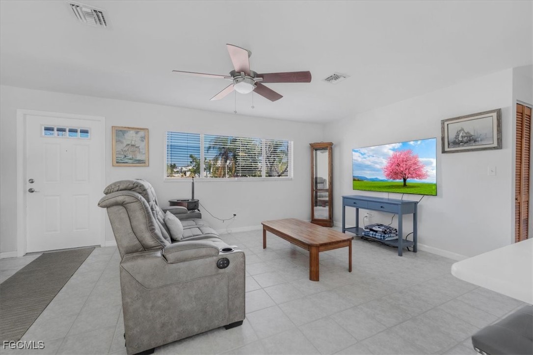 13239 Caribbean Boulevard Fort Myers, FL 33905 - Photo 9 of 37 a living room with furniture and a flat screen tv