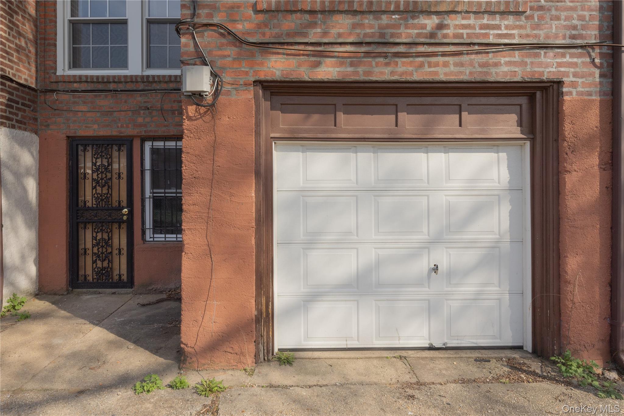 179-65 Selover Road Queens, NY 11434 - Photo 25 of 33 Garage9'1" x 16'3"Single-car garage with a paneled white door, set within a brown frame