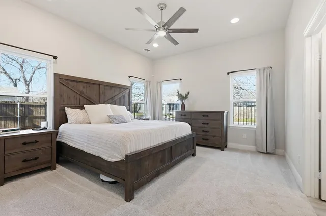 a spacious bedroom with a bed and a window