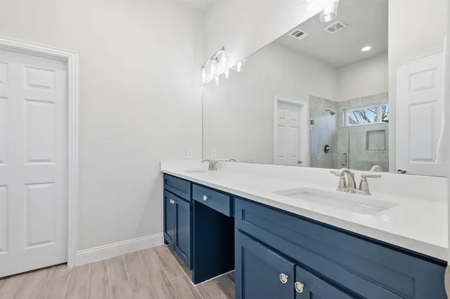 a bathroom with a double vanity sink and a mirror