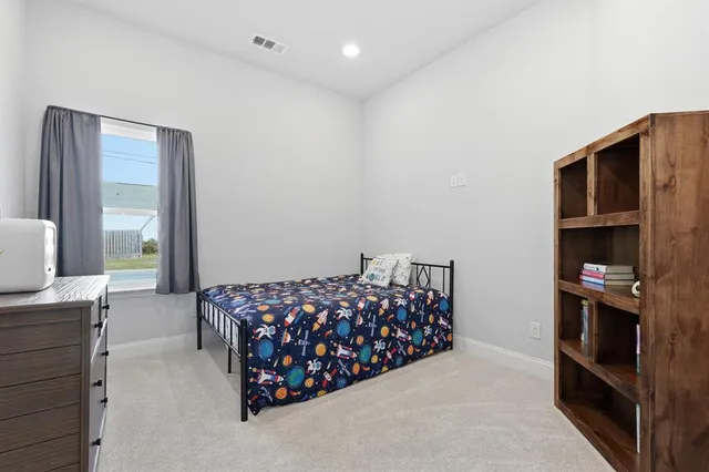 a bedroom with a bed and a cabinets