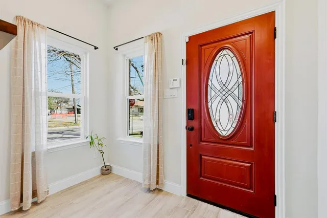 a view of a hallway with wooden floor and entryway