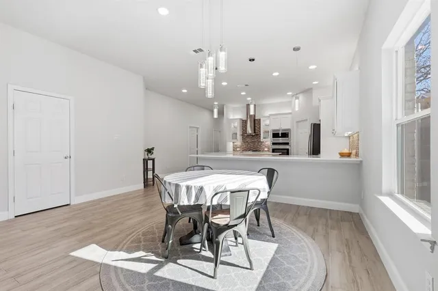 a view of a dining room with furniture and wooden floor