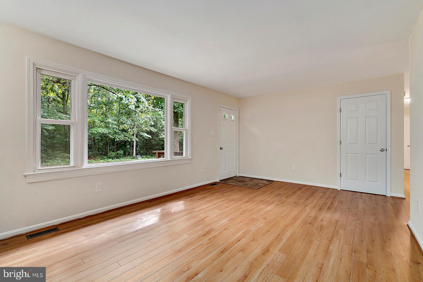 5466 Sumerduck Road Sumerduck, VA 22742 - Photo 3 of 29 a view of an empty room with wooden floor and a window