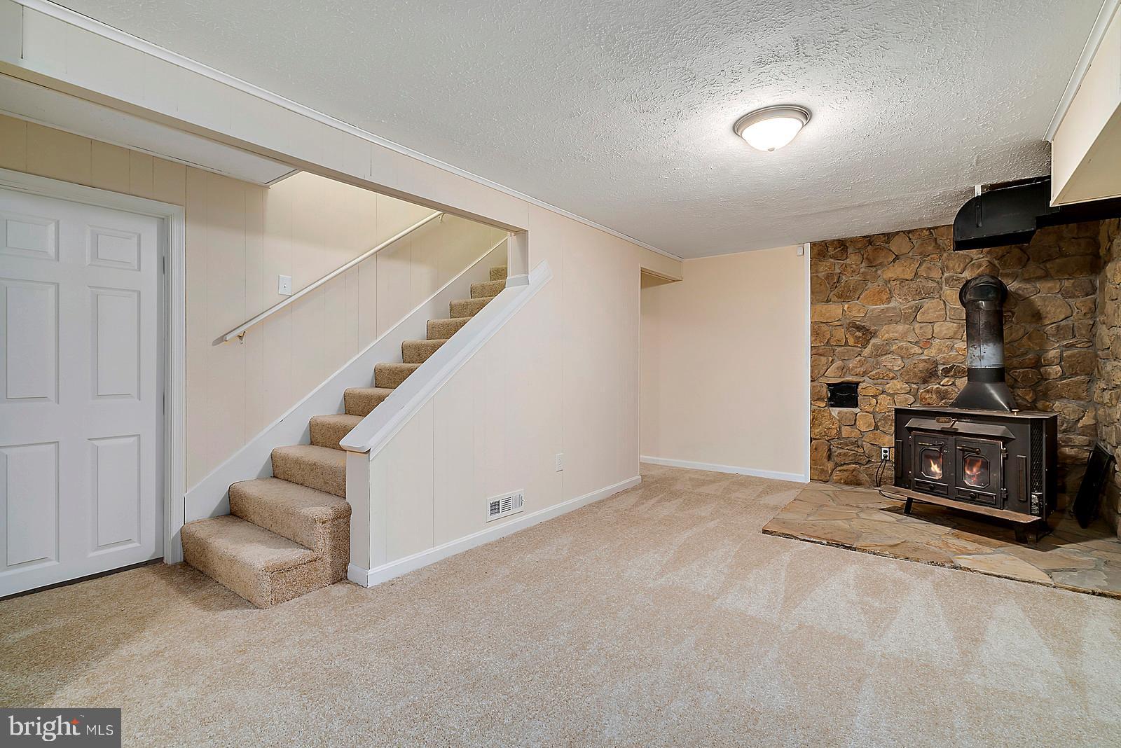 5466 Sumerduck Road Sumerduck, VA 22742 - Photo 22 of 29 a view of an empty room with fireplace and stairs