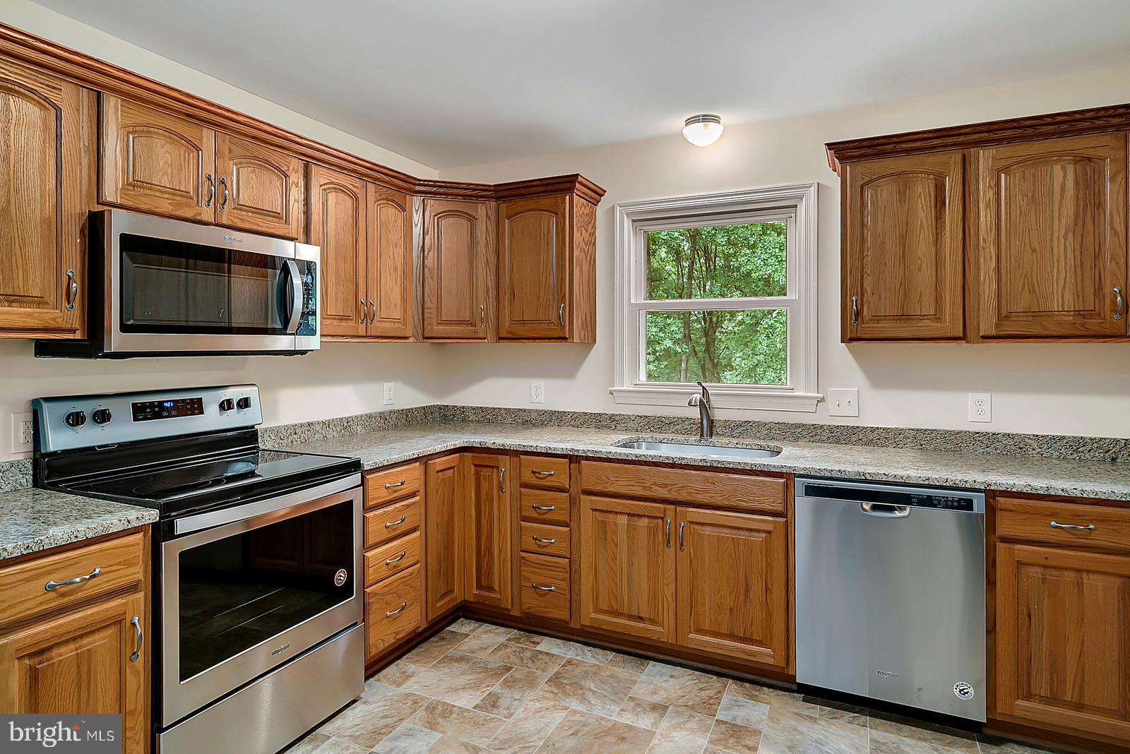 5466 Sumerduck Road Sumerduck, VA 22742 - Photo 8 of 29 a kitchen with granite countertop cabinets stainless steel appliances and a window