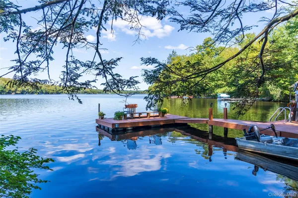 a backyard of a house with lots of green space and lake view