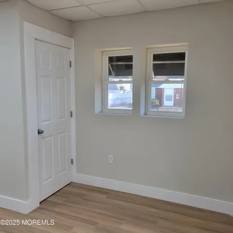 a view of room with window and hardwood floor
