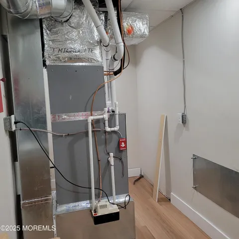 a view of a room with water heater and storage