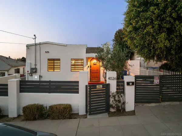 a view of a house with stairs and a tree
