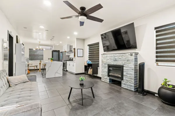 a living room with furniture fireplace and flat screen tv