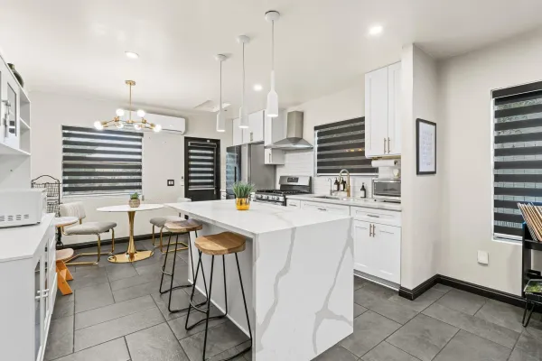 a kitchen with stainless steel appliances kitchen island granite countertop a sink and cabinets