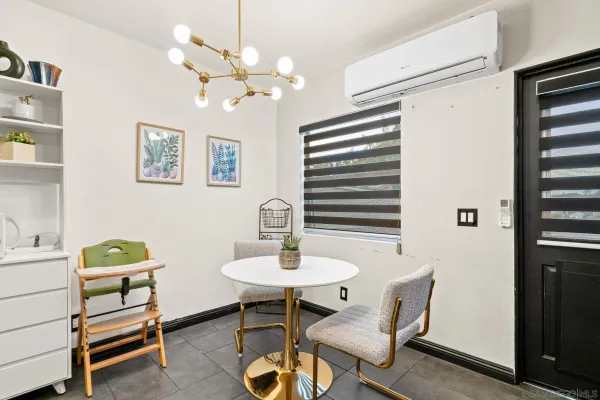 a dining room with furniture and window
