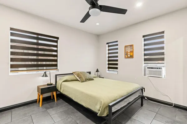 a bedroom with a bed and a window