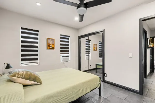 a bedroom with a bed and a window