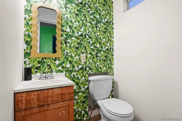a bathroom with a toilet sink and mirror