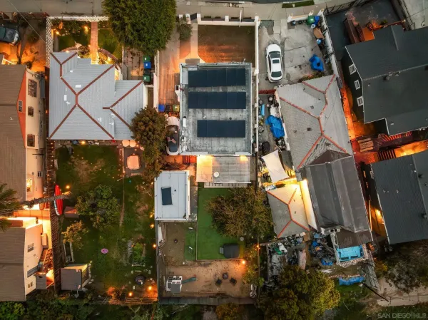 an aerial view of a house with a yard and potted plants