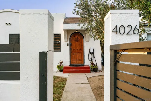 a front view of a house with parking area