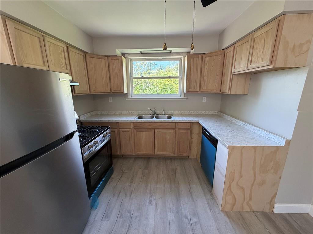3079 Mt Troy Road Pittsburgh, PA 15212 - Photo 10 of 30 a kitchen with stainless steel appliances a sink a stove a refrigerator and cabinets