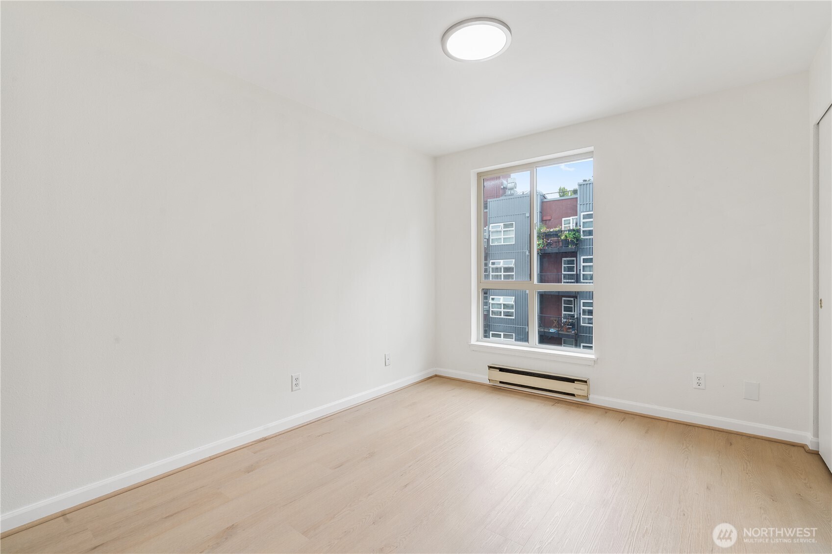 769 Hayes Street, Unit 405 Seattle, WA 98109 - Photo 13 of 29 an empty room with windows