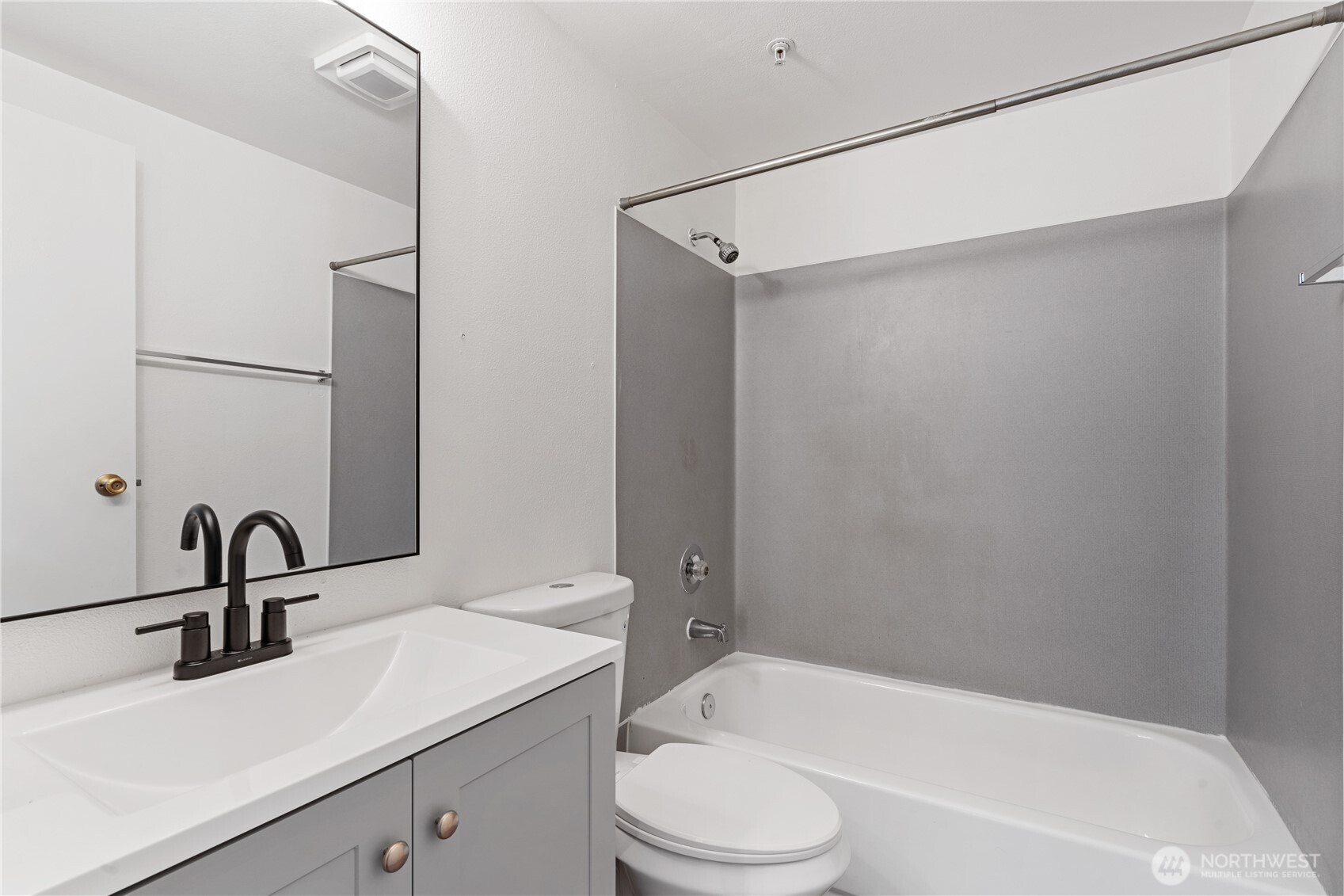 769 Hayes Street, Unit 405 Seattle, WA 98109 - Photo 15 of 29 a bathroom with a sink a mirror toilet and bathtub