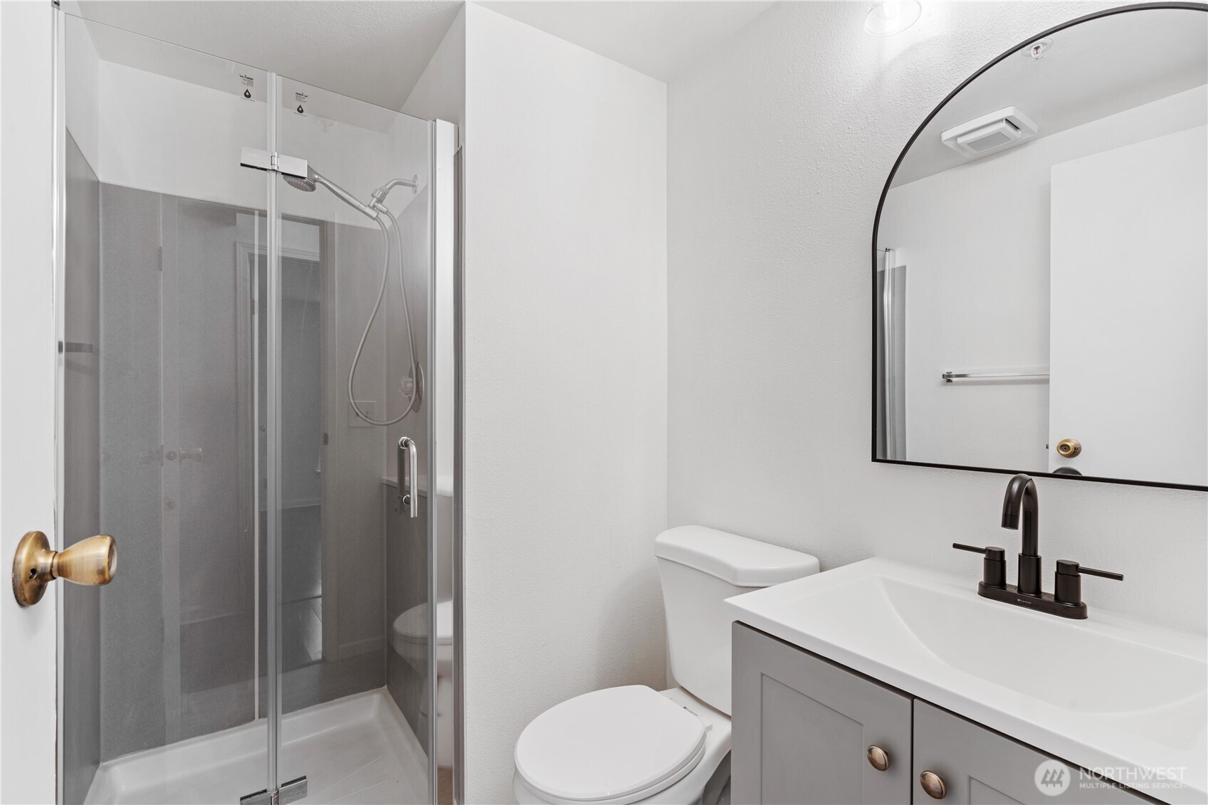 769 Hayes Street, Unit 405 Seattle, WA 98109 - Photo 18 of 29 a bathroom with a toilet sink vanity and shower